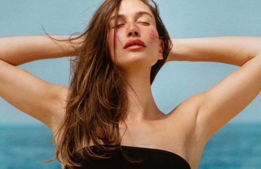 Et si le nouveau geste beauté de l’été tenait à la taille ? Hailey Bieber imagine un bijou de corps pour transporter son baume à lèvres