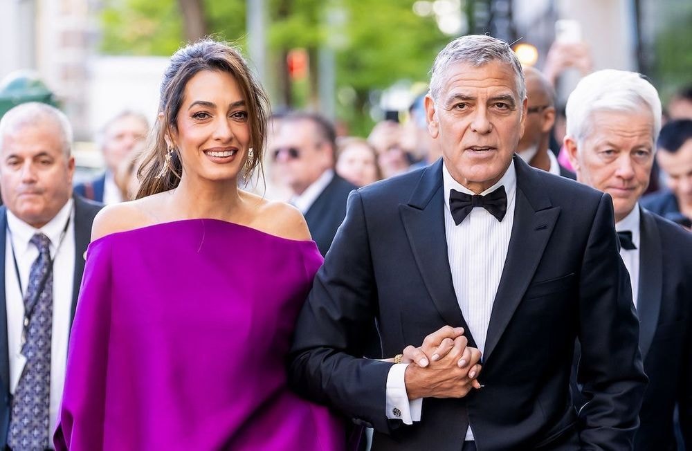 En mini-robe fuchsia aux épaules dénudées, Amal Clooney fait sensation au bras de George Clooney